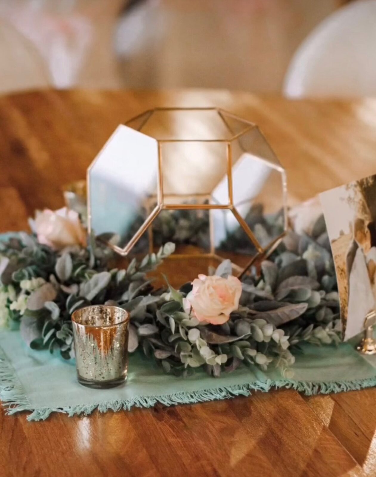 Elegant centerpiece arrangement with coordinated florals and table styling details.